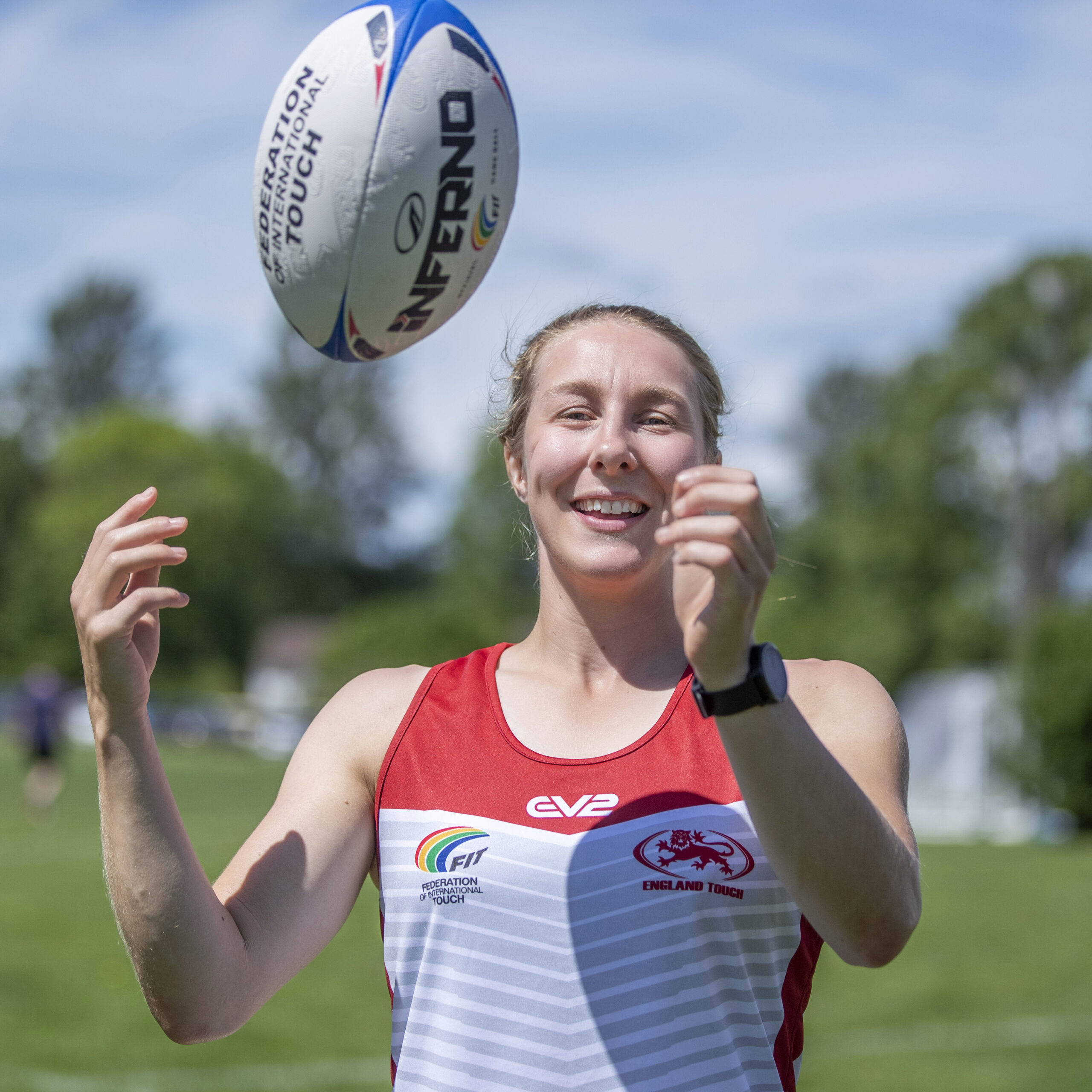 Image of Anna in an England Touch vest throwing a rugby ball